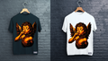 Two t-shirts with angel designs on a brick wall background