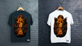 Black and white t-shirts with a graphic design of faces and wings on hangers against a brick wall.
